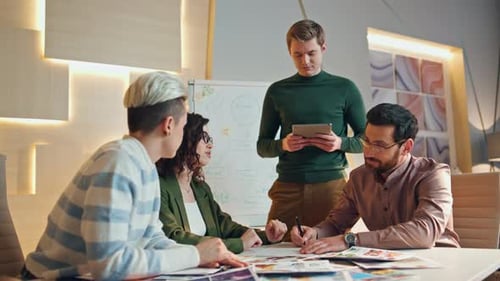 Creative coworkers brainstorming new business strategy in modern company office