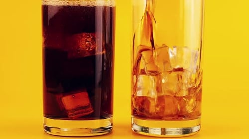 Cold Soda Being Poured Over Ice Cubes