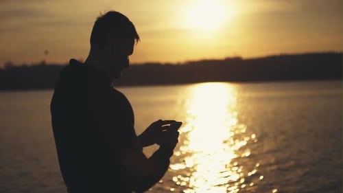 Silhouette d'un homme utilisant un téléphone