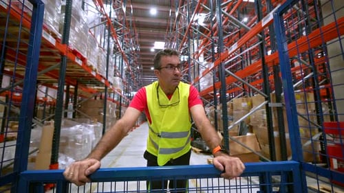 Homme contrôlant la distribution dans un entrepôt de stockage