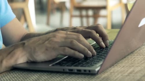Man Using Laptop and Drinking Cocktail Sitting in Cafe 30s