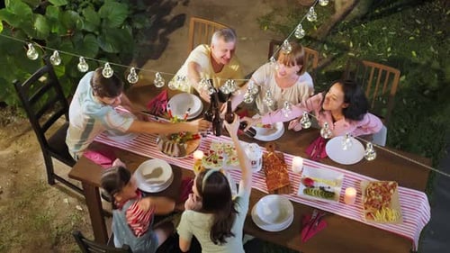 Multi-ethnic big family having fun, enjoy party outdoors in the garden.