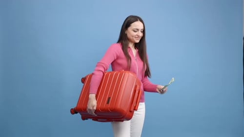Woman with Suitcase and Money Smiling