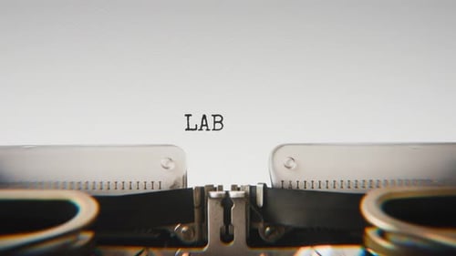 Old mechanical typewriter typing Lab Report in a close-up view.