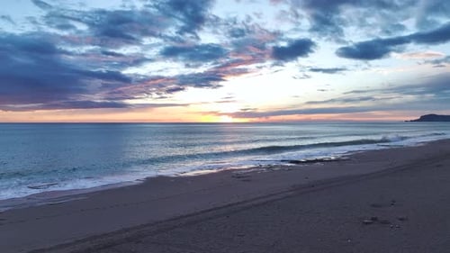 Aerial Video of Romantic Twilight Over Ocean With Red and Orange Skies Stretching Into Infinity