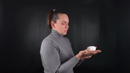 Woman Taking White Pills From Bottle