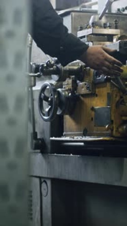 Metal lathe operation by skilled worker in industrial workshop