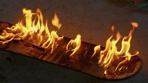 Skateboard Engulfed in Bright Orange Flames