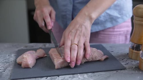 the chef prepares meat in the kitchen