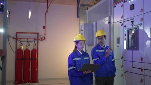 Engineers are checking electronic system at basement.