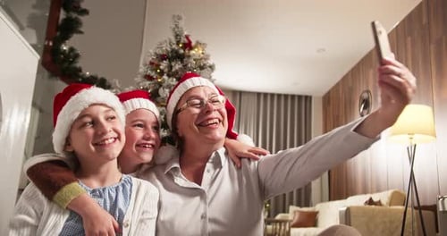 Smiling Family Taking Christmas Selfie Together