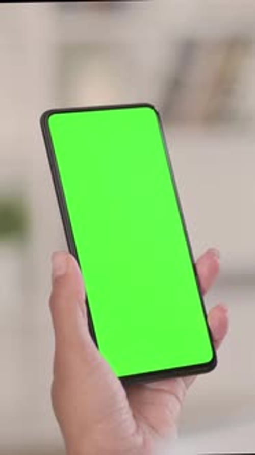 African Woman Using Smartphone with Green Chroma Key Screen, vertical video
