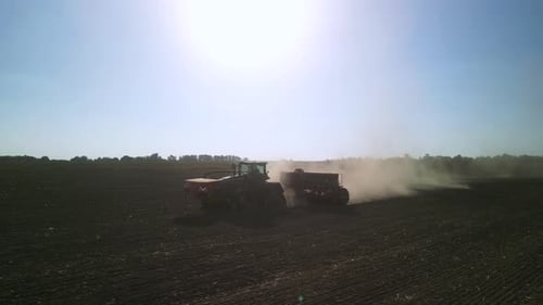 Tractor on the field seeding wheat