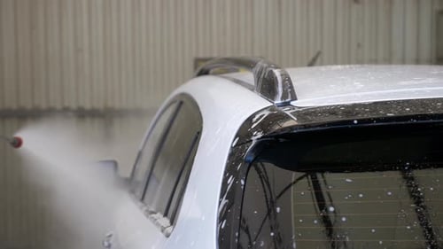 Closeup of a Woman Washing a Car at a Selfservice Car Wash