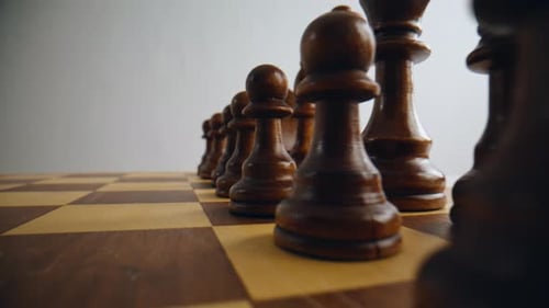 Brown Wooden Chess Pieces Positioned on Board Closeup Dark Figures Standing