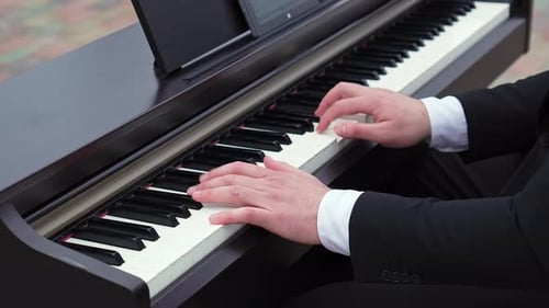 Man Plays a Melody on the Piano