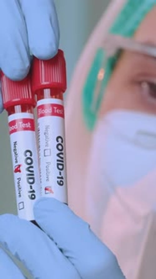 Medical Worker Holds COVID-19 Positive Blood Vials