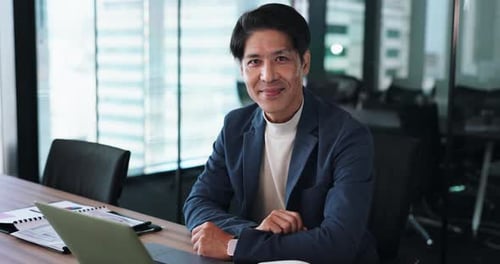 Asian man, face and laptop in office for business, professional and pride for career growth