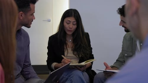 Informal Group of Business People Sitting in a Circle Discussing a Project