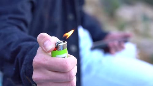 flicking on a lighter to smoke