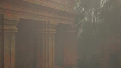 Foggy View of Building With Columns and Trees in Background