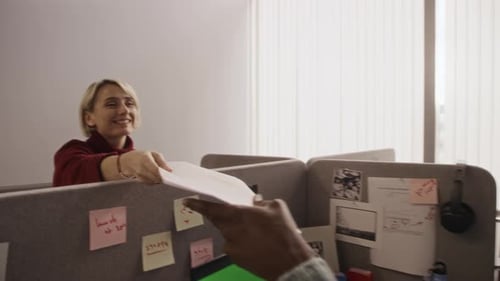 Office Employees Collaborating on Paperwork in Professional Workspace