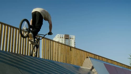 BMX Rider Performing Trick on Ramp at Skate Park