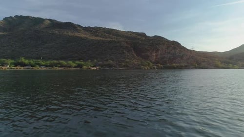 AERIAL - Hovering Over Desert Lake with Desert Mountains in the Background (Canyon Lake)