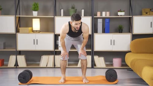 Man Taking a Break During Intense Home Workout