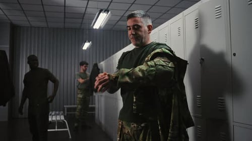 Soldiers Relaxing Talking and Undressing in Military Base Locker Room After Finished Mission