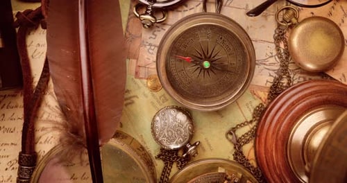 Vintage style travel and adventure. Vintage old compass and other vintage items on the table.