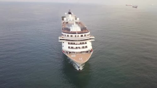 Large cruise ship at sea - Aerial footage at sunrise.