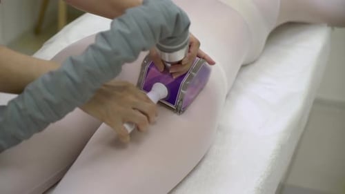 Woman Receiving Massage Treatment with White Bodysuit