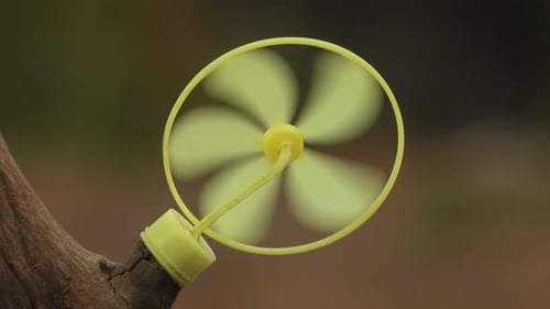 Toy fan in wind . yellow.