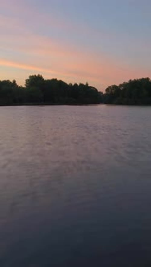 Fast Low Angle Flying Over the Lake in Sunny Morning Aerial View Vertical Video