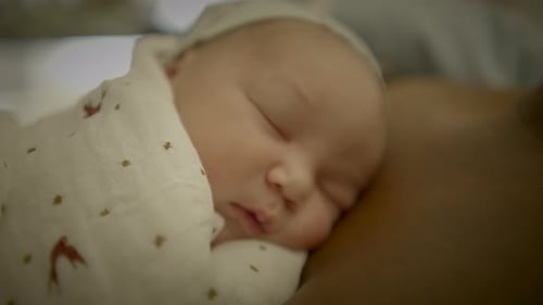 Infant Sleeping Peacefully on Adult