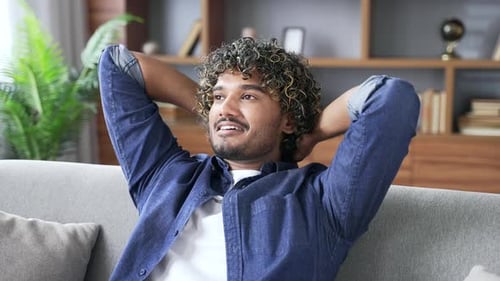 Young Adult Relaxing on a Sofa Indoors