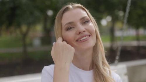 MiddleAged Blonde Woman Enjoying the Park Looking Directly at the Camera