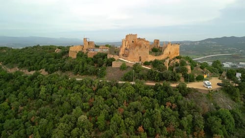 Ruined castle in Europe aerial footage cinematic medieval era circular images on the top of the moun
