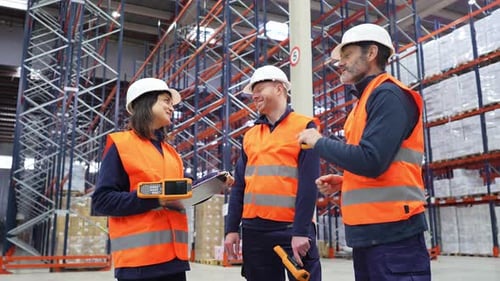 Warehouse Workers Discussing Logistics and Inventory Management