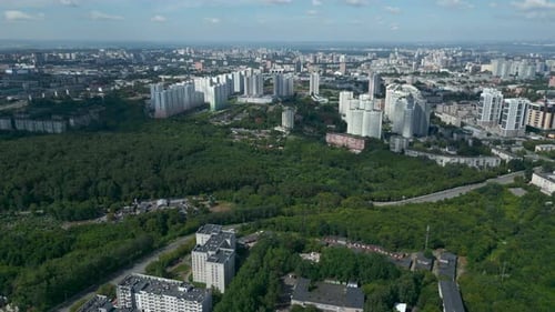 Aerial View Flying Over Residential Buildings and Green Forest Park Clip