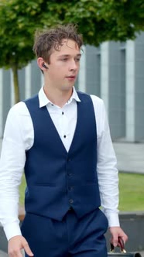 Young Man in Suit Walking in Urban Area