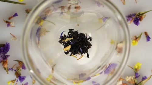 Top View of Herbal Tea Leaves and Dried Flowers in Glass Teapot