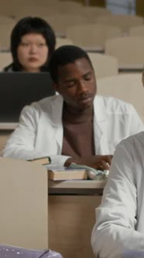 Black Male Medical Student Writing during Lecture Class at College