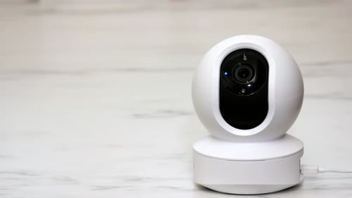 CCTV IP wireless security camera on remotely operated Smart security home moving to film around the