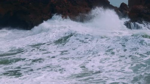 Powerful Ocean Wave Crashing Against Coastal Rocks