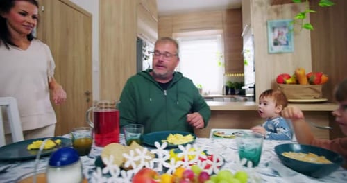 Family Eating Breakfast Together at Kitchen Table