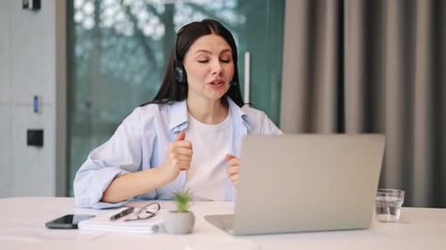 Woman Using Laptop During Video Conference Call at Home