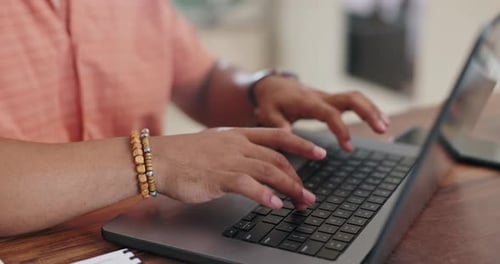 Hands Typing on Laptop Keyboard at Home