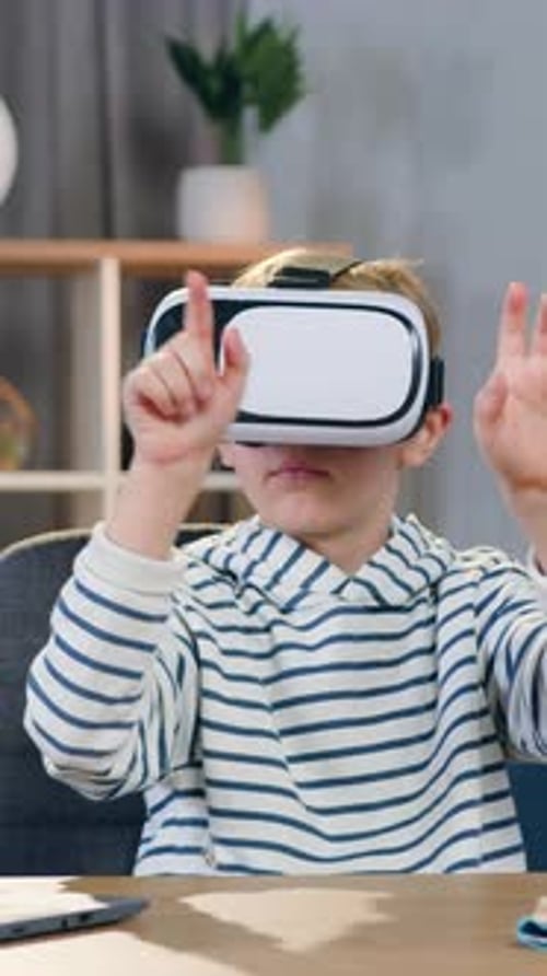 Likable Clever Hardworking Teen Schoolboy Sitting at the Table in His Room and Doing School Home